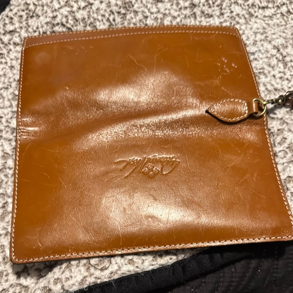 Brown Leather Wallet with Strap Closure and Supple Texture